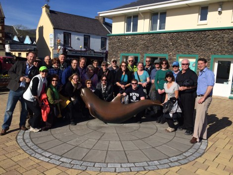 International travelers enjoying the 'Historic Dingle' Walking-Tour. Pictured with our award-winning, 100% Dingle tour-guides at the statue of Fungi the Dolphin, one of the most famous Dolphins in the world! All our tours depart daily from the Fungie statue (beside the Tourist information Office)
